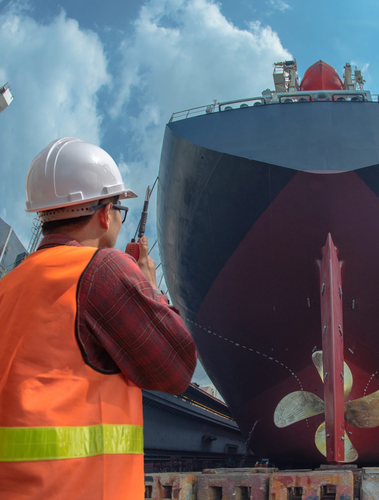 supervisor, foreman, inspector, surveyor takes final inspection of the cleaning, repairing, recondition of over hull of the commercial ship in dry dock yard, ready to delivery the ship to the sea